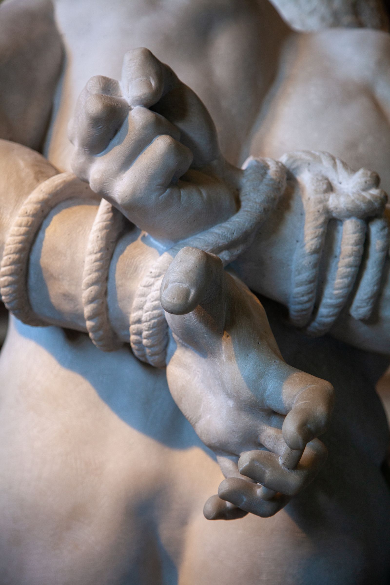 Bound marble hands, carved
